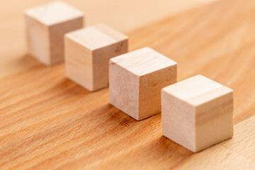 Wooden toy blocks. Geometric wood cubes in a row. Conceptual blank