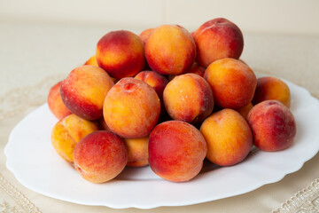 There is a dish of peaches on the table