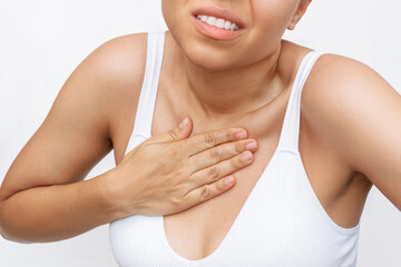 Cropped shot of a young woman keeps his hand on her chest in pain isolated on a white background....