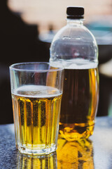 Beer glass and beer bottle. Cold alcohol drinks. Pub concept. Gold colored beer on table. Oktoberfest concept. Icy beer. Summer refreshment. Bar concept. 