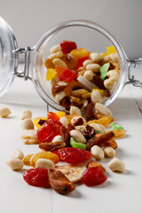 A handful of dried fruits in a glass jar
