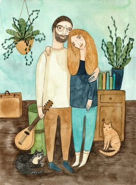 A couple standing in their home with a cat and a mandolin