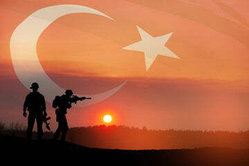 Fototapeta na wymiar Silhouettes of soldiers on a background of Turkey flag and the sunset or the sunrise. Concept of crisis of war and conflicts between nations. Greeting card for Turkish Armed Forces Day, Victory Day.