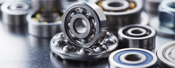 different bearings, vernier caliper and ruler on metal background. Part of mechanism.