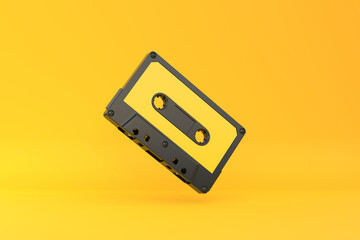 Vintage audio tape cassette on a yellow background. Front view with copy space. 3d rendering illustration