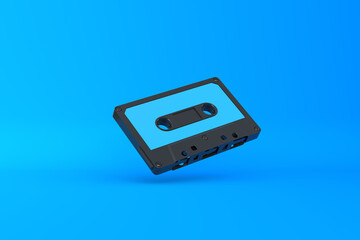 Fototapeta premium Vintage audio tape cassette on a blue background. Front view with copy space. 3d rendering illustration