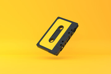 Vintage audio tape cassette on a yellow background. Front view with copy space. 3d rendering illustration