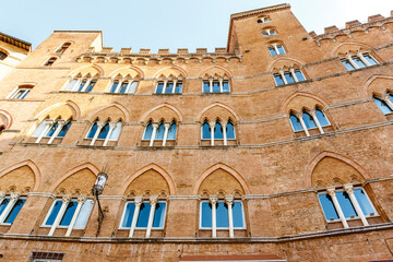Facade of old Renaissance residential buildings at the Campo square in Siena, Tuscany, Italy, Europe