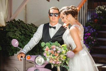 Newlyweds went on motorcycle trip. Wedding photo shoot on scooter