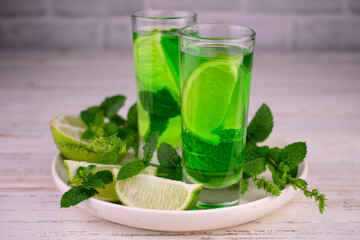 Mint liqueur with lime on a white tray.
