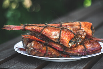 smoked fish sea bass on the table. homemade smoking