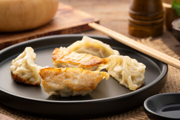 gyoza,Japanese style grilled dumplings with pork and vegetables on black plate