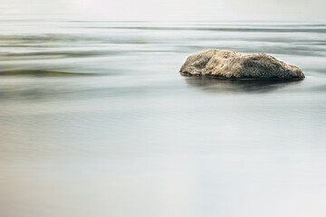 Long exposure of a river with silk effect in the water, with the rocks in focus.