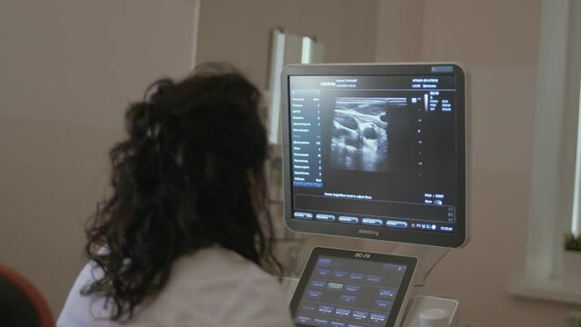 4K. In the hospital, a Doctor does a close-up ultrasound procedure