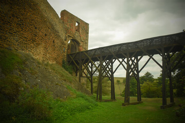 Ruined medieval castle, wooden bridge and moat