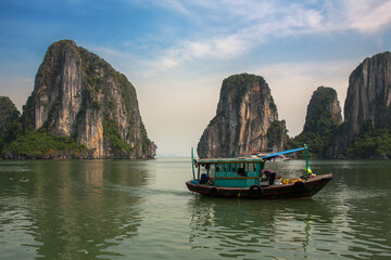 A local boat between Đảo Đầu Gỗ and Hòn Cặp Ngàn, two of the many hundreds of islands in Ha Long Bay, Quảng Ninh Province, Vietnam