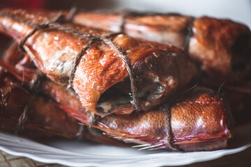 smoked fish sea bass on the table. homemade smoking
