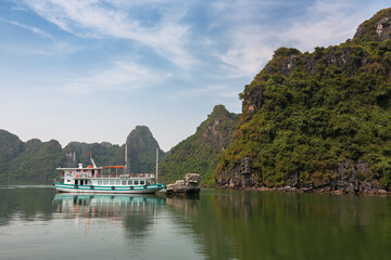 Boat at anchor by Hon Vit Con (Duckling Rock), Halong Bay, a popular travel and tourism destination in Quang Ninh Province, Vietnam