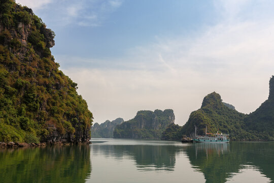 Boat at anchor by Hon Vit Con (Duckling Rock), Halong Bay, a popular travel and tourism destination in Quang Ninh Province, Vietnam