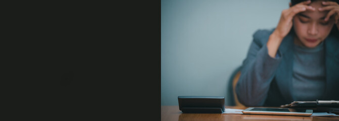 Fototapeta premium Stressed businesswoman,Frustrated and upset in business pressure and overworked at office. Asian female working on laptop, feel tire and headache. Stressed and Frustrated concept-