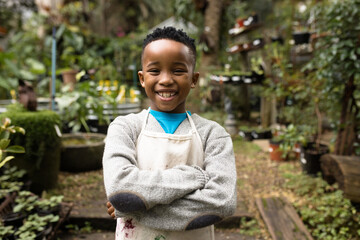 Portrait of happy african american boy in garden