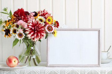 Summer mockup with flowers in a glass jug.