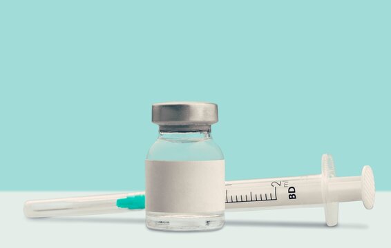 medical liquid for injection in a glass vial on the desk