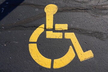 Yellow Handicap parking sign on a parking area