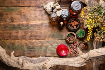 Herbal medicine concept background. Dry natural ingredients and remedy bottle on the wooden table...