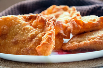 deep-fried golden chebureks or dumplings are laid out on a plate