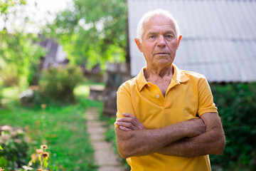 Senior man standing in backyard