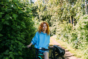 Fototapeta na wymiar A young woman uses a modern electric bicycle for sports and outdoor recreation 