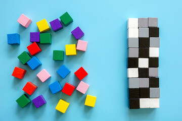 Colored cubes and a line of black and white cubes. Diversity and inclusion concept.