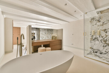 Interior of contemporary bathroom with shabby beige walls and partitions and white door at home