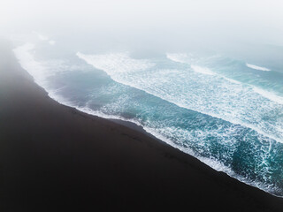 Fototapeta na wymiar Pacific ocean coast with black volcanic sand in Kamchatka, Russia.