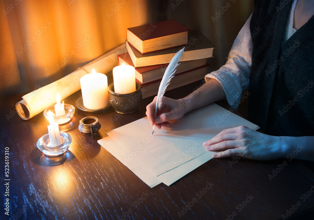 Wall mural Girl writes a letter with a pen on paper