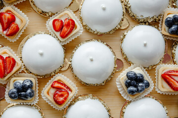 cupcakes with icing, sweets on the plate,  candy bars.