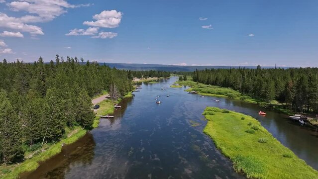 Flying up the Henrys Fork river as people are kayaking downstream during summer vacation in Idaho.