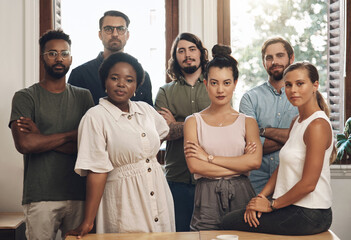 Serious business people standing with arms crossed, looking confident and showing teamwork in an office together at work. Portrait of diverse creative employees expressing power, unity and success - Powered by Adobe
