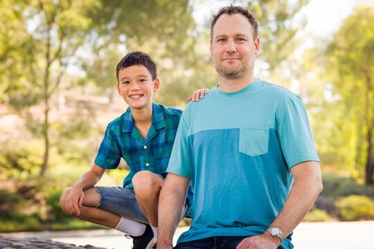 Outdoor portrait of mixed race Chinese and Caucasian father and son.