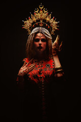 Ethnic dancer wearing gold crown and dreadlocks, in trance