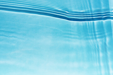 Water blue background. Abstract blue backdrop, texture of transparent, clear water with waves and ripples