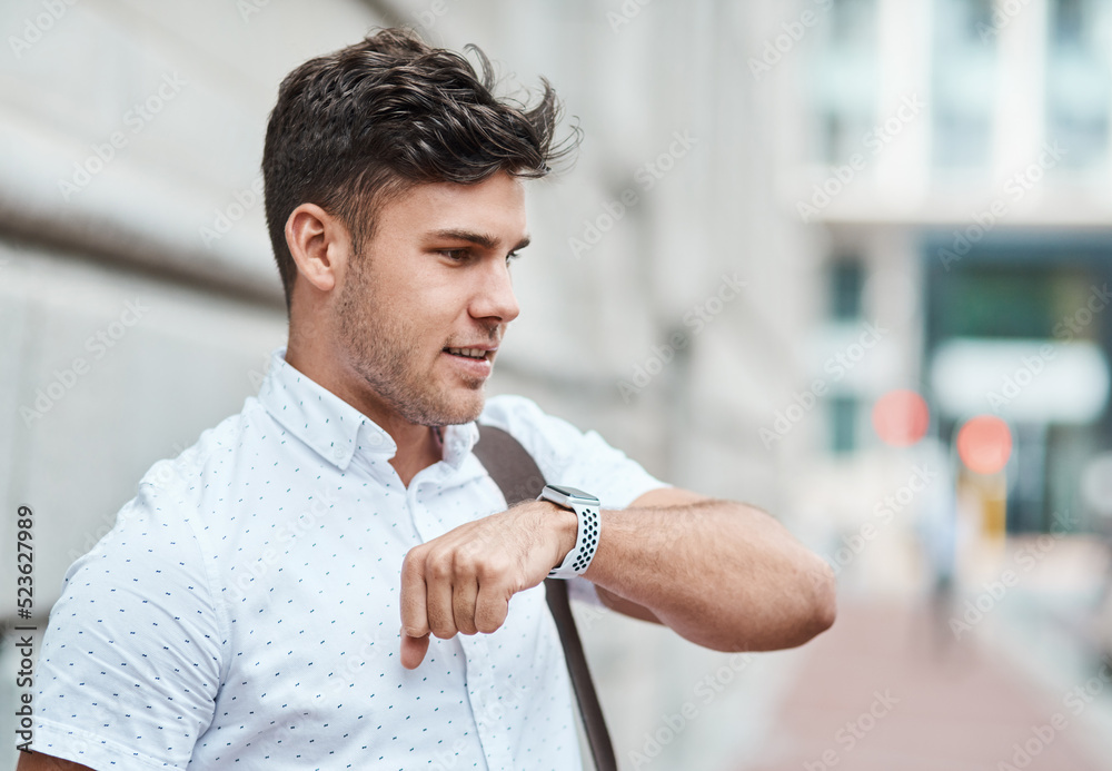 Poster chatting on a smartwatch with a young creative business man or intern commuting in the city. hailing