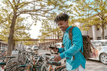 Guy choosing bike looking at smartphone