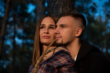 portrait of a couple in autumn forest on sunset