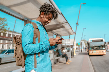 Guy looking at smartphone standing sideways to camera