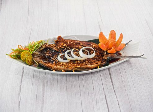 Bangus Bistek with onin rings served in dish isolated on grey wooden background side view of fastfood