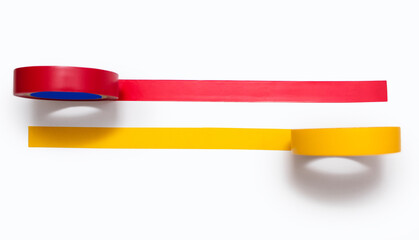 Yellow and red electrical tape glued to a white background. Red and yellow sticky tapes for...