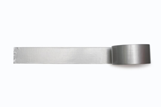 A spool of gray duct tape is unwound and pasted to a white background. Adhesive tape for repair work and construction. Adhesive tape for moisture protection or for assembly and packaging