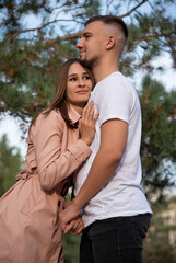 Fototapeta premium hugging couple walking in the autumn park near lake